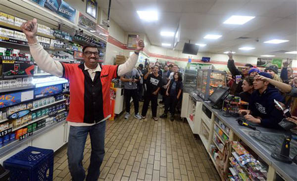 7-Eleven store clerk M. Faroqui celebrates after learning the store sold a winning Powerball ticket on Wednesday, Jan. 13, 2016 in Chino Hills, Calif.  One winning ticket was sold at the store located in suburban Los Angeles said Alex Traverso, a spokesman for California lottery. The identity of the winner is not yet known. (Will Lester/The Sun via AP) MANDATORY CREDIT